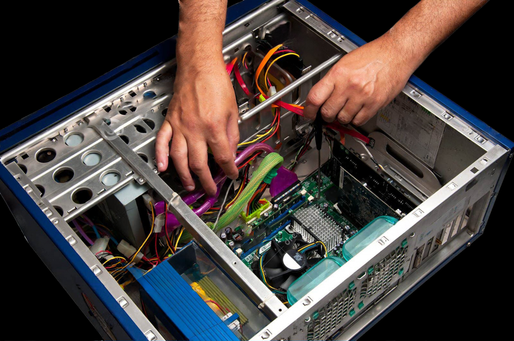 Open computer on a black background with man's hands working on some parts